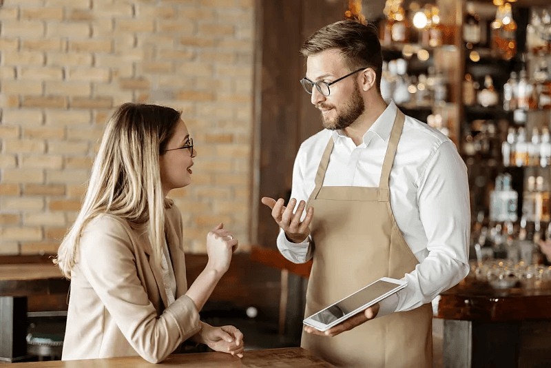 Restaurant managers reviewing business performance on a tablet