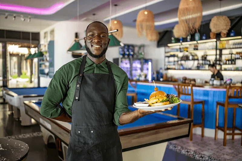 Restaurant team member serving guests at a group venue