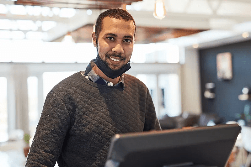 Restaurant team member managing live orders at the counter