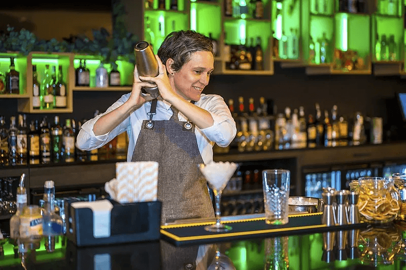 A bartender preparing a drink during service