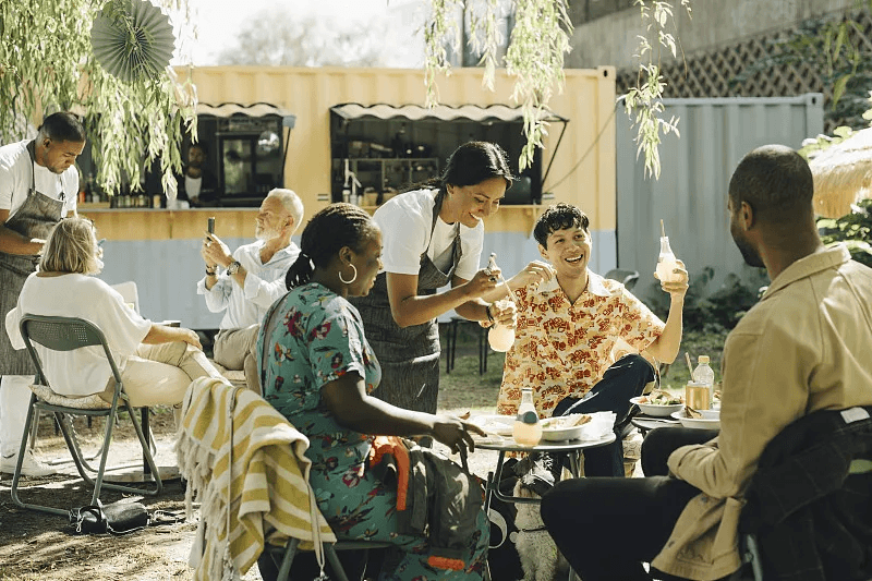 Guests enjoying food near a mobile food service venue
