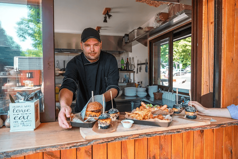 Fresh food being handed to customers from a compact service kitchen