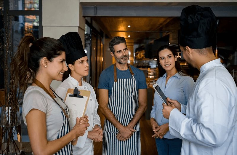 Restaurant operators discussing service workflows