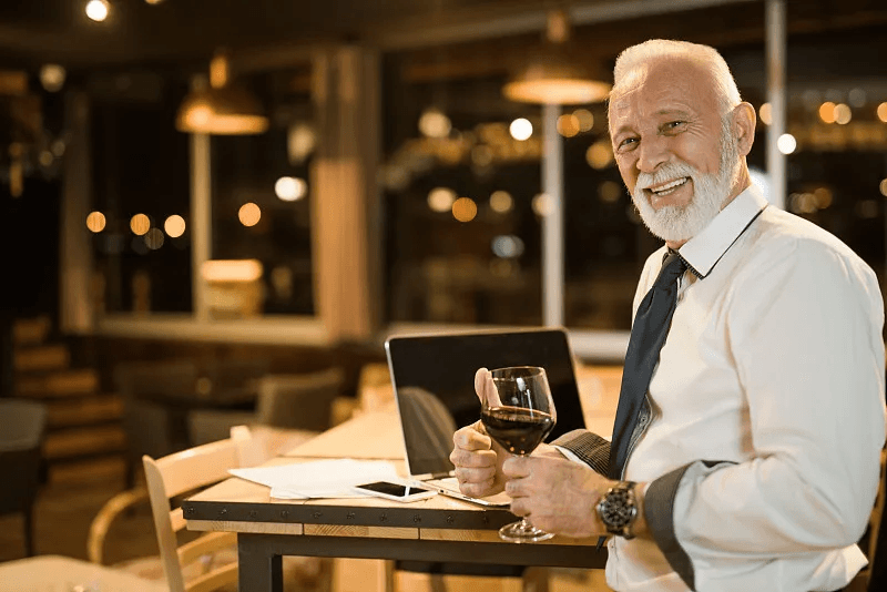 Restaurant manager reviewing service operations on a laptop