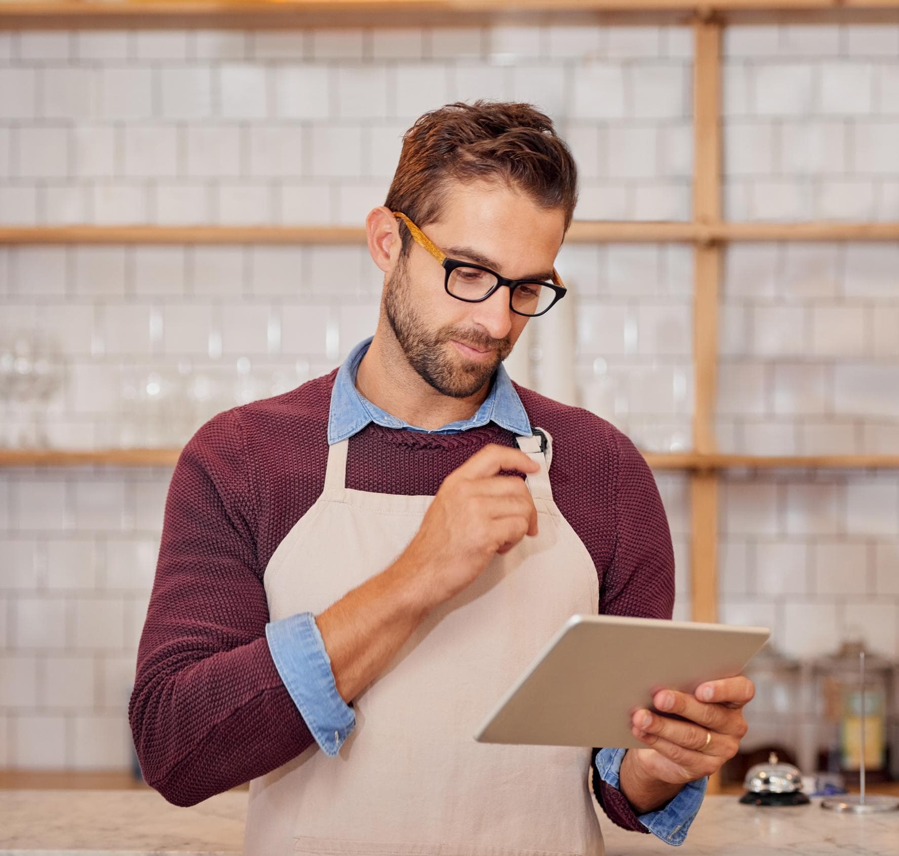 Cafe owner using Intelura POS on a tablet