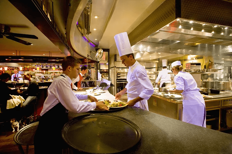 Restaurant teams coordinating service in a professional kitchen