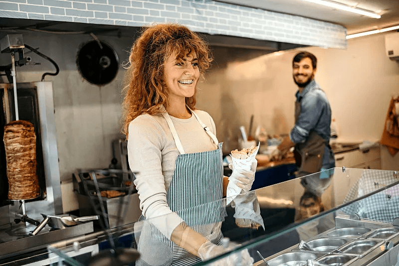 A quick-service team preparing food behind the counter