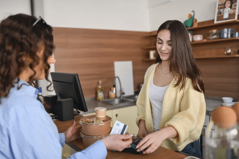 A customer paying for a takeaway order at the counter